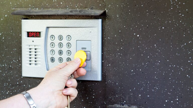 Close-up of uses intercom in steel door